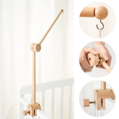 Wooden mobile holder positioned above baby crib
