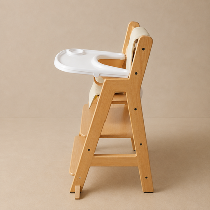 High chair for baby first meals at the family dining table