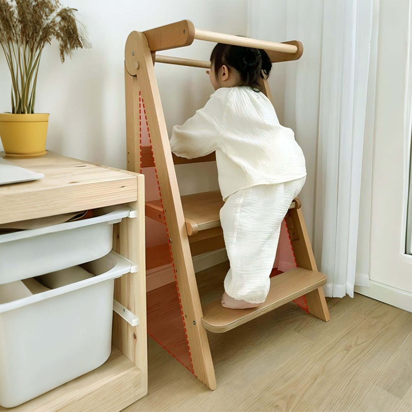 Child washing hands using kitchen helper tower