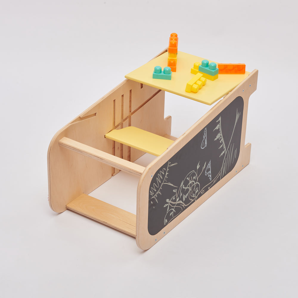 Preschooler drawing at the convertible wooden kids desk