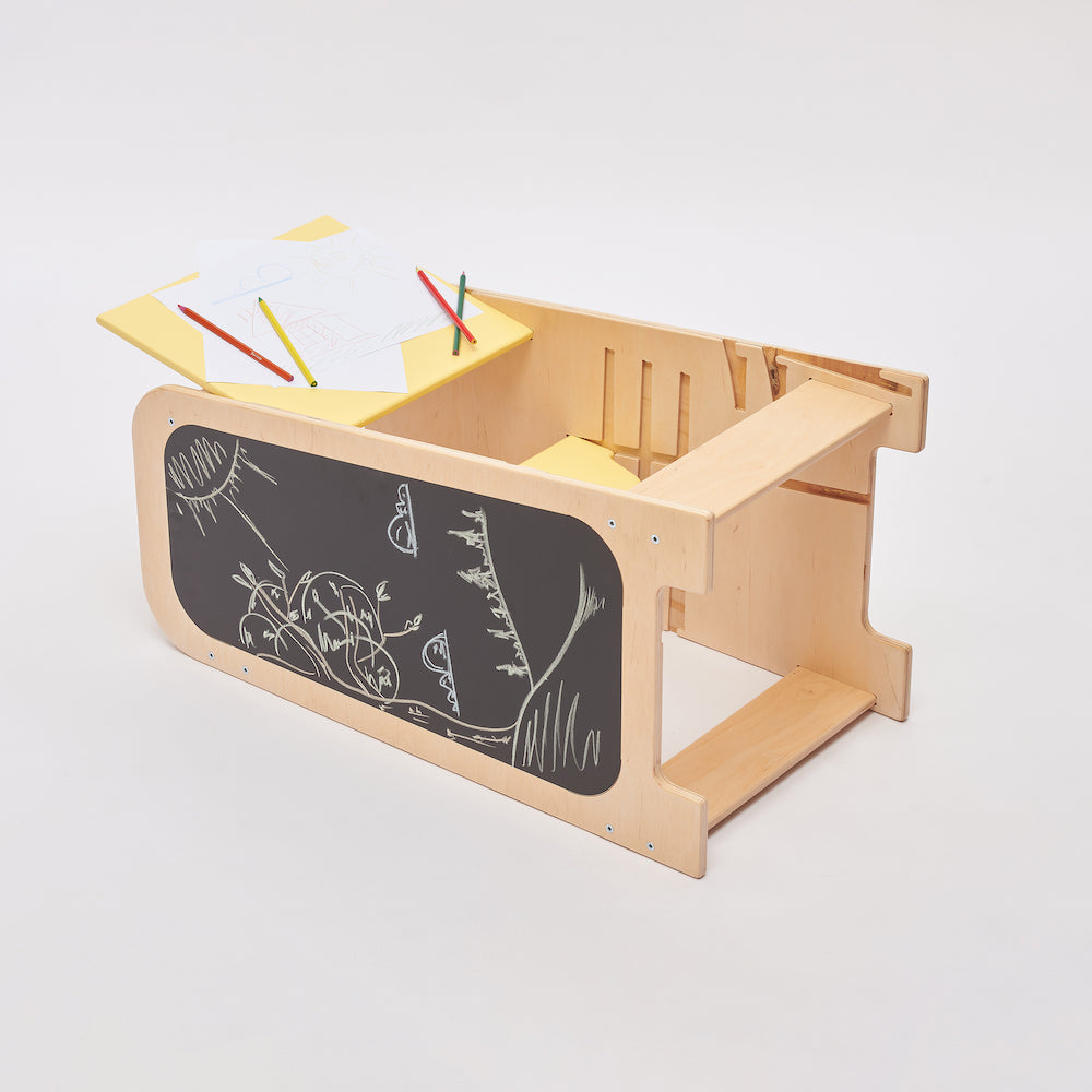 Toddler seated at the learning tower in desk mode