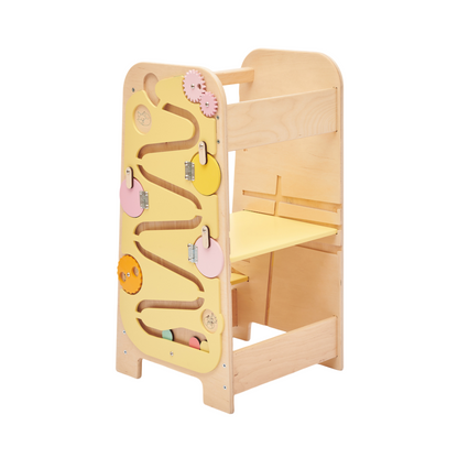 Toddler exploring fine motor activities on the side busy board
