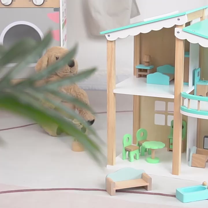 Children arranging furniture in dollhouse rooms