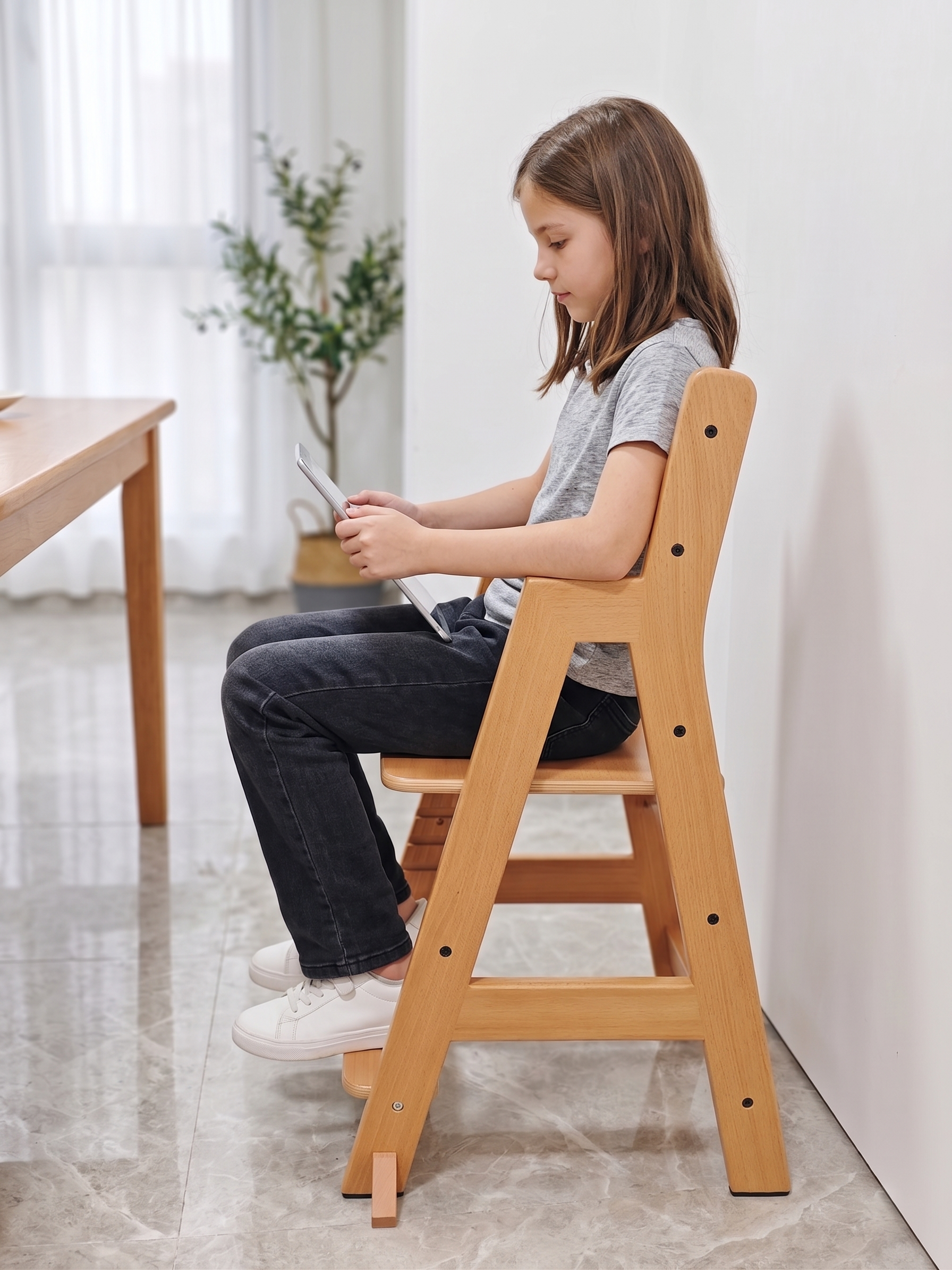 Wooden high chair with adjustable footrest for improved sitting comfort